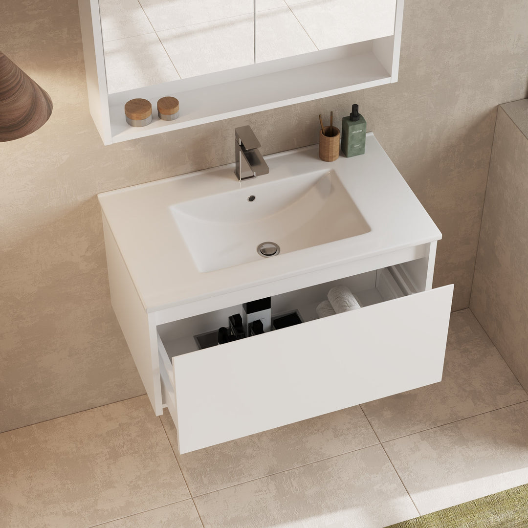 Close-up of drawer handle inset on gloss white front, emphasizing minimalist design.