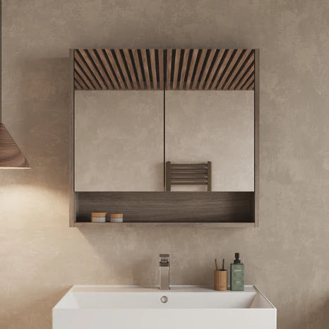 Double-door mirror cabinet in Nebraska Oak finish mounted above a bathroom sink, mirrors closed